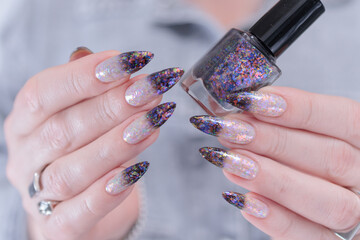 Female hands with long nails and white and black thermo french manicure