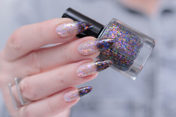 Female hands with long nails and white and black thermo french manicure	