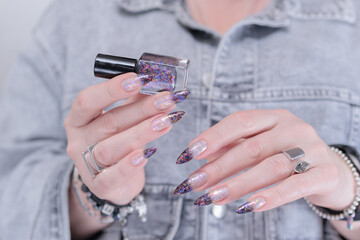 Female hands with long nails and white and black thermo french manicure