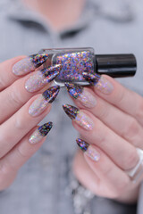 Female hands with long nails and white and black thermo french manicure	