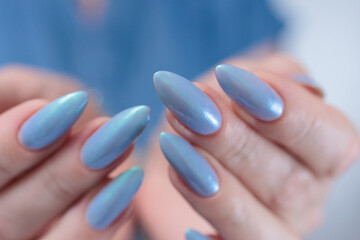 beautiful hand with long nails and light baby blue manicure