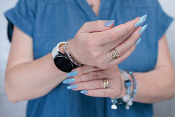 beautiful hand with long nails and light baby blue manicure