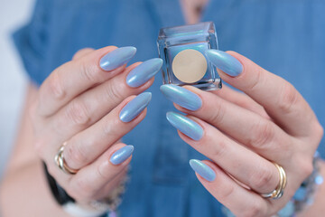 beautiful hand with long nails and light baby blue manicure