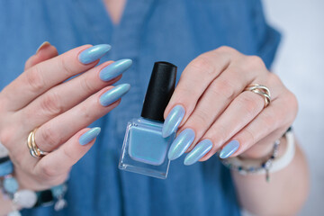 beautiful hand with long nails and light baby blue manicure