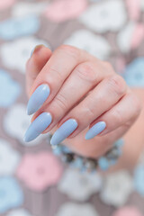 beautiful hand with long nails and light baby blue manicure