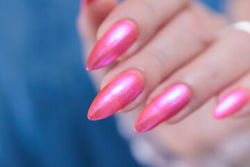 beautiful female hands with long nails and bright neon pink nail polish