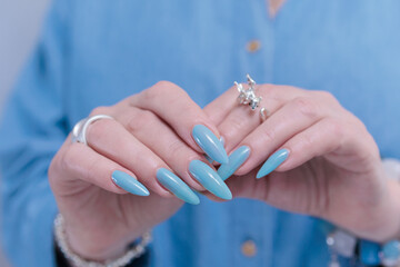 Silver dragon ring in woman's hands