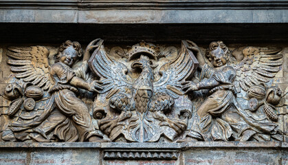 Medieval stone panel with angels and royal coat of arms. Medieval Green Gate in Gdansk	