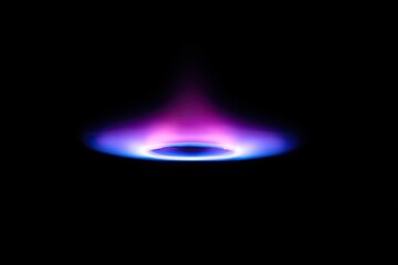 Abstract illustration of a bright, vibrant blue and purple flame on black background