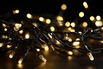 Close-up of warm, twinkling string lights against a dark background