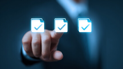 A man is pointing at three files with a check mark on them