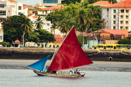 A rustic wooden sailboat, traditional from the state of Maranh&atilde;o, sailing in front of the city of S&atilde;o Lu&iacute;s, northeastern Brazil.