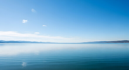 Calm lake under a bright blue sky
