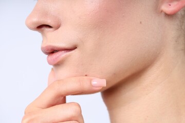 Woman with normal skin on light background, closeup