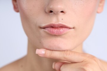 Obraz premium Woman with normal skin on light background, closeup