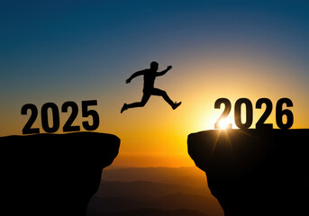 Silhouette of person jumping from 2025 cliff to 2026 during sunset symbolizing new year transition