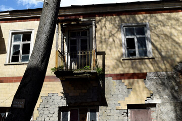 An old abandoned house with a collapsed balcony