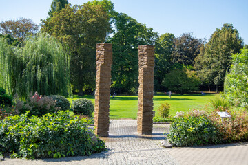 Serene park with stone pillars and lush greenery