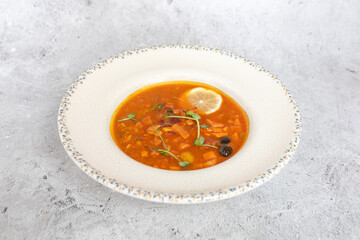 Traditional Georgian bean soup Lobio with herbs in ceramic plate