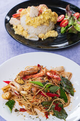 Spicy spaghetti with shrimps in tomato sauce close-up on a plate.