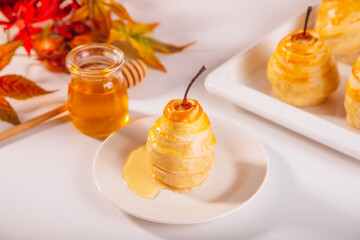 Pears in puff pastry dough drizzled with honey. Healthy and organic food.