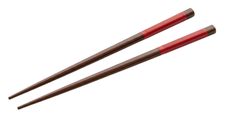 Isolated pair of wooden chopsticks with red band, traditional Asian culinary utensils