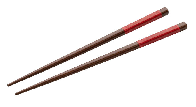 Isolated pair of wooden chopsticks with red band, traditional Asian culinary utensils