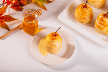 Pears in puff pastry dough drizzled with honey. Healthy and organic food.