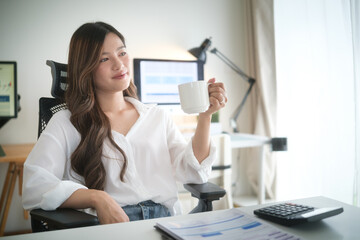 Businesswoman enjoying a quiet coffee moment at her desk.