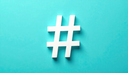 Obraz premium The crisp white hashtag symbol casts a subtle shadow against a vivid teal background, providing a clean and modern minimalist aesthetic.