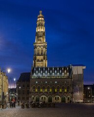 Fototapeta premium A view at dusk of the famous belfry of Arras in the Place des Heros town square