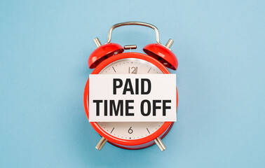 A red alarm clock with a white paper that says Paid Time Off