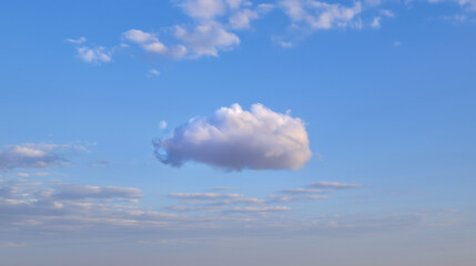 wideangle. Single fluffy cloud in a vast blue sky, serene atmosphere. travel magazines, destination branding, designed for travel destination branding, inspires travel planning.