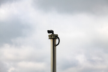 CCTV camera against cloudy sky