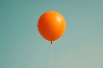Single Orange Balloon Floating Against Teal Sky Keywords: balloon, orange, floating, helium