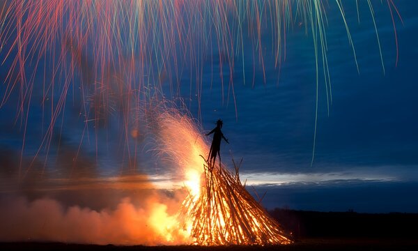 Bonfire Night Celebration with Fireworks and Silhouette.