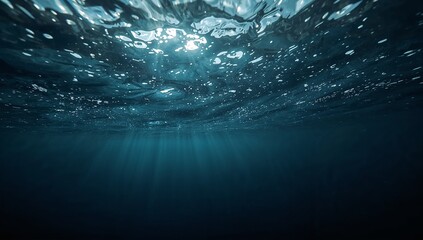 Obraz premium Dive into the mesmerizing depths of the ocean, where sunlight dances through the water creating a serene and captivating underwater world experience today