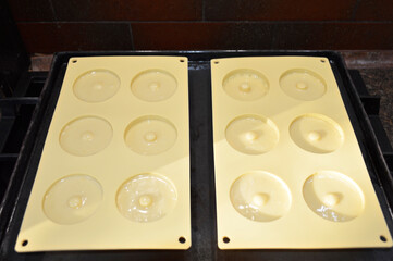 pouring liquid muffin batter into silicone baking mold. making dessert at home. tasty food for kids and adults