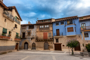 Historic traditional buildings in the Plaza Mayor (main square) of Ráfales, Aragon, Spain.