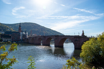 Fototapeta premium Historic stone bridge over river with scenic backdrop