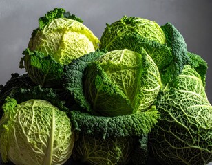 Fototapeta premium Fresh cabbages arranged beautifully on a dark background highlighting their vibrant green color and intricate leaf patterns