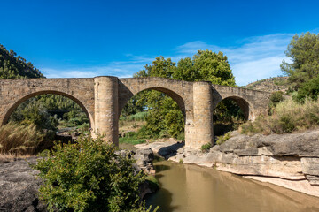 Magnificent Gothic Pont de Vilomara Bridge Barcelona Spain 14th Century Medieval Stone Arch Structure and Blue Sky