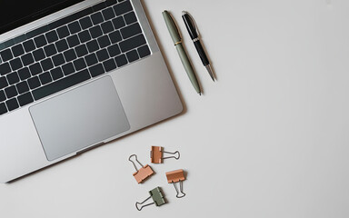 Minimalist Soft Autumn Feminine White Desk Flatlay Laptop with paper clips an pens