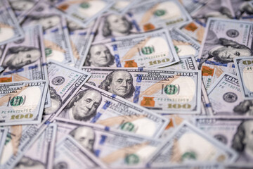 Money background with 100-dollar bills. Texture of US money currency. 100 USD banknotes in focus. American hundred-dollar money backdrop. Pattern of US dollars. Money for finance concept.