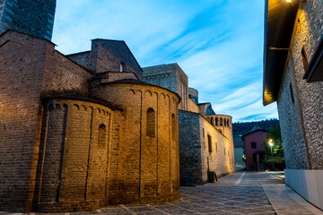 The Romanesque apses of the Cathedral of Santa Maria and the Church of Sant Miquel in La Seu d'Urgell, illuminated at twilight. Catalonia, Spain.