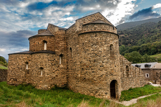 The ancient Romanesque architecture of the historic Sant Serni de Tav&egrave;rnoles monastery under a dramatic, stormy sky in the Catalan Pyrenees