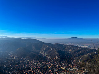 Aerial view of a historic mountain city with red rooftops