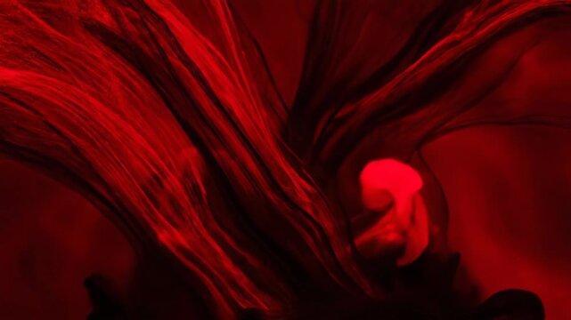 Abstract Swirling Crimson and Black Threads - This video features an abstract composition of flowing, swirling crimson and black threads.