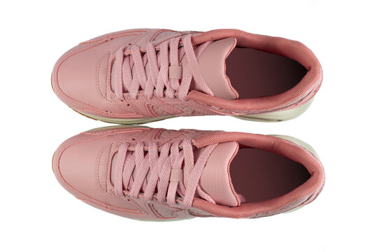 Pair of woman's sneakers isolated from background. Pink color. Top view