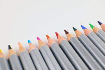 Sets of colored pencils placed neatly on a plain background
